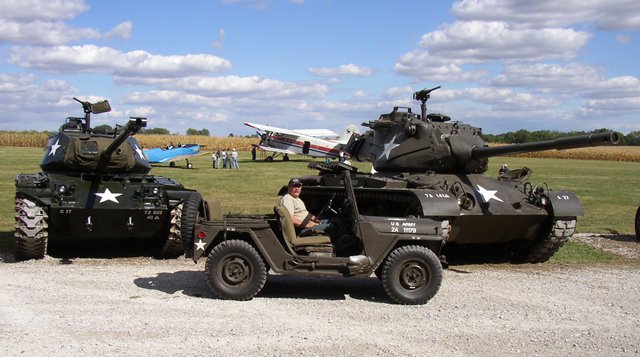 Scott in M151 with background HMVs